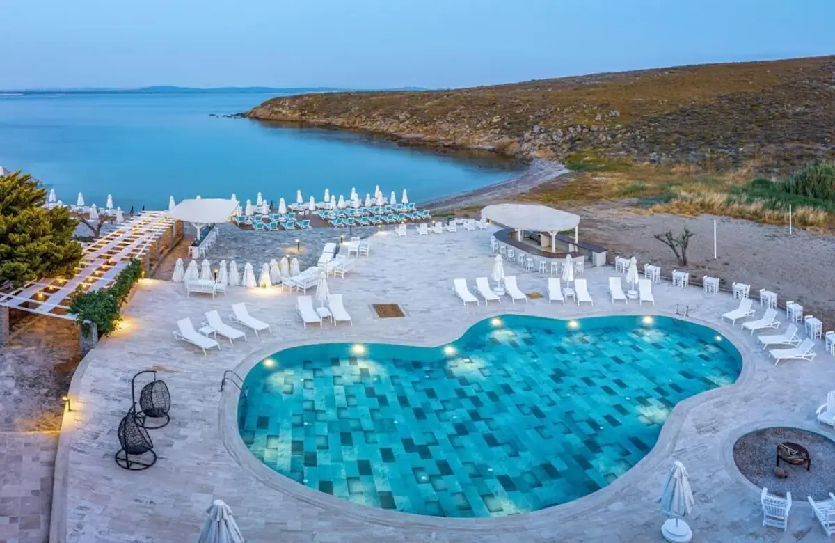 Pelagos Otel Bozcaada seafront pool and beach terraces at dusk